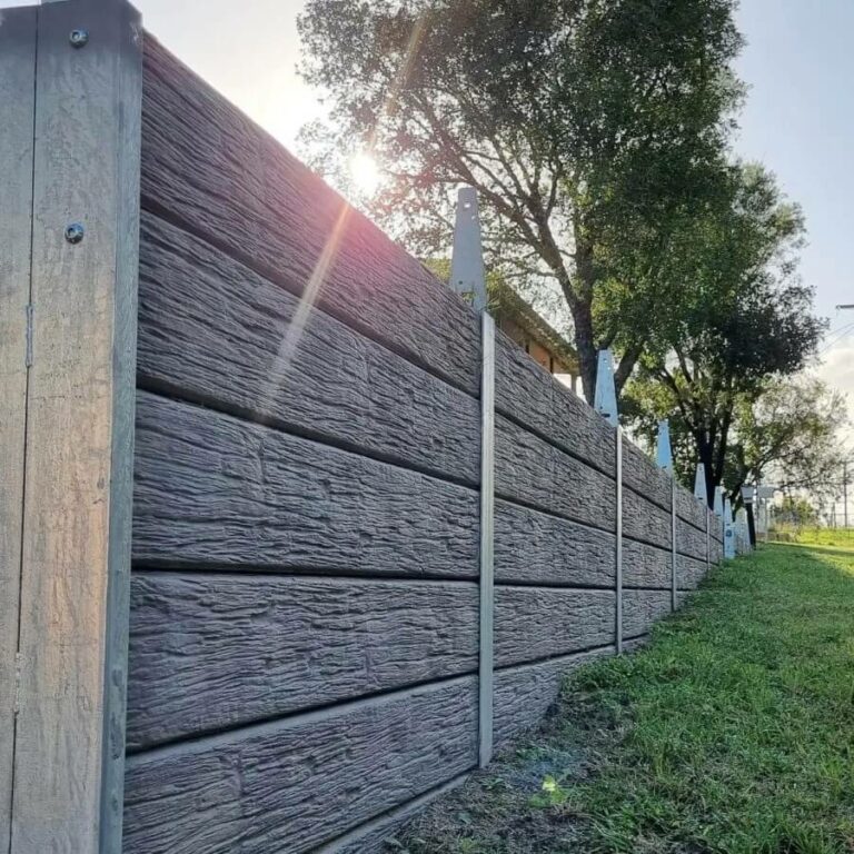 Grey concrete sleeper retaining wall